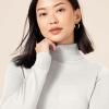 imageAmazon Essentials Womens ClassicFit Lightweight LongSleeve Turtleneck Sweater Available in Plus SizeIvory